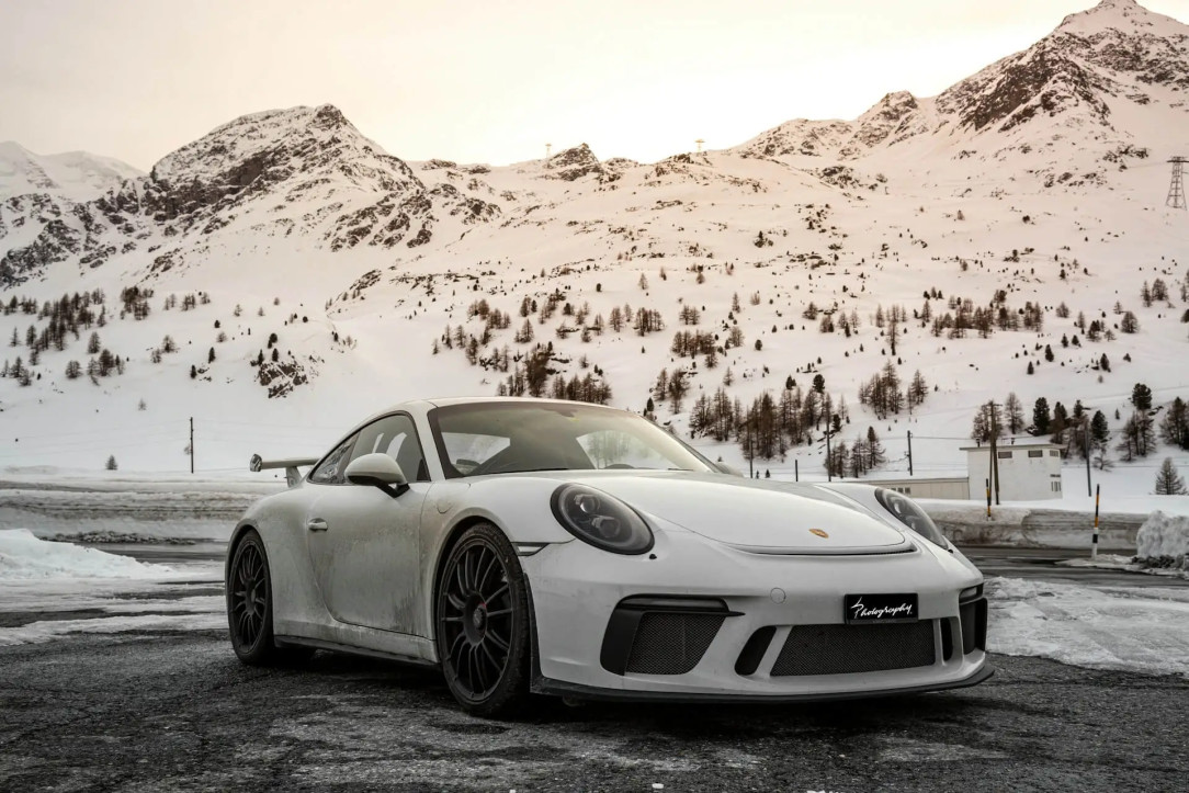 Porsche car on a winter landscape in the mountains