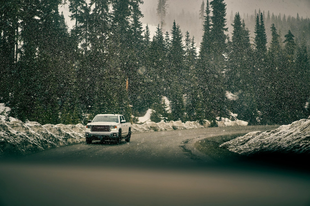 a white SUV on the snowy road in winter