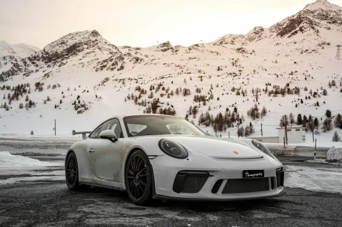 Porsche car on a winter landscape in the mountains